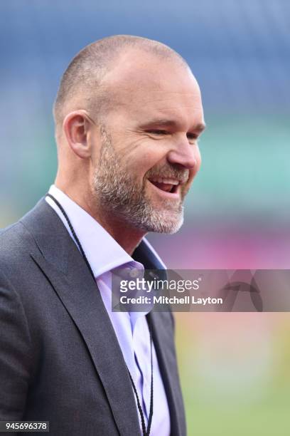 Baseball color analyst David Ross looks on before a baseball game between the New York Mets and Washington Nationals at Nationals Park on April 8,...