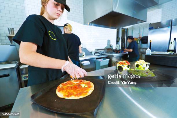 fast food restaurant young kitchen staff worker preparing convenience food - fast food stock pictures, royalty-free photos & images