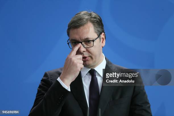 Serbian President Aleksandar Vucic and German Chancellor Angela Merkel hold a joint press conference prior to their meeting in Berlin, Germany on...