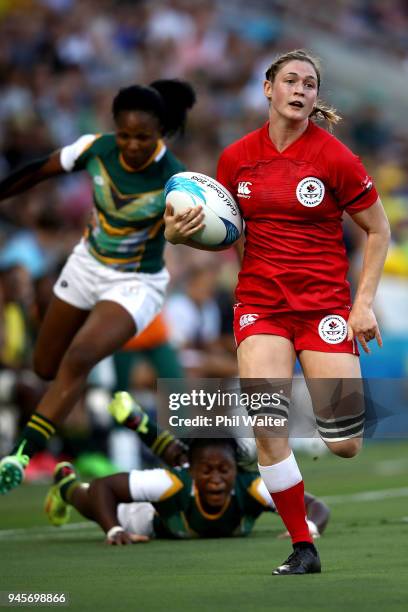 Brittany Benn of Canada is tackled in the match between South Africa and Canada during Rugby Sevens on day nine of the Gold Coast 2018 Commonwealth...