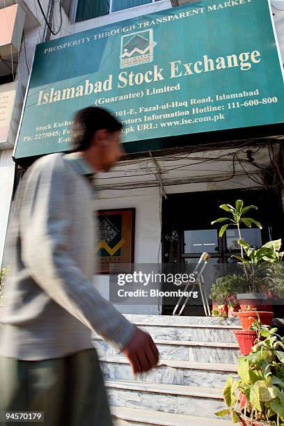 Man walks past the Islamabad Stock Exchange in Islamabad, Pakistan, on Tuesday, Jan. 1, 2008. The Islamabad Stock Exchange is one of three stock...