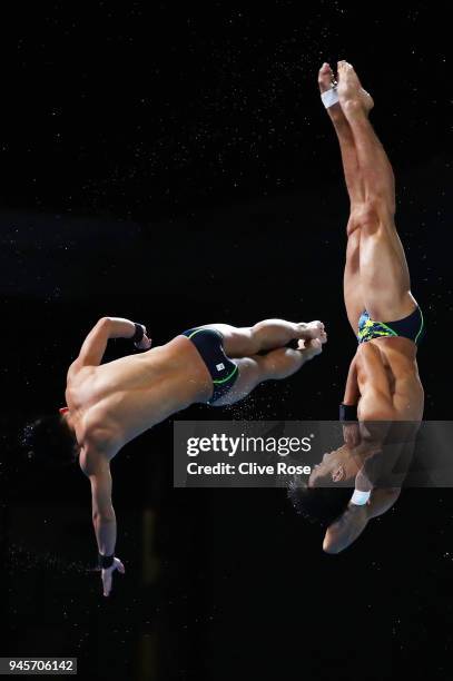 Gabriel Gilbert Daim and Muhammad Syafiq Puteh of Malaysia competes in the Men's Synchronised 3m Springboard Diving Final on day nine of the Gold...