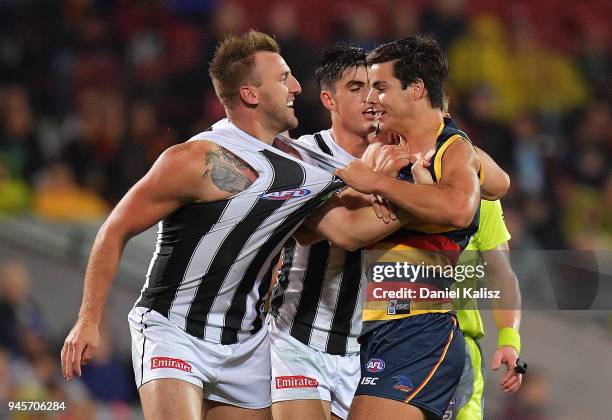 Lynden Dunn of the Magpies and Darcy Fogarty of the Crows wrestle during the round four AFL match between the Adelaide Crows and the Collingwood...