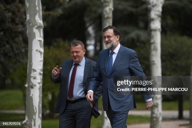 Spanish Prime Minister Mariano Rajoy and Danish Prime Minister Lars Lokke Rasmussen walk in the garden of the Moncloa Palace in Madrid on April 13,...