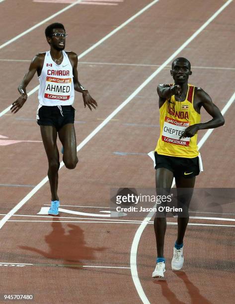 Joshua Kiprui Cheptegei of Uganda celebrates winning gold as he crosses the line ahead of Mohammed Ahmed of Canada in the Men's 10,000 metres final...