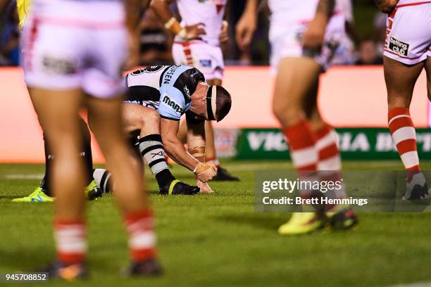 Paul Gallen of the Sharks reacts after sustaining a leg injury during the round six NRL match between the St George Illawarra Dragons and the...