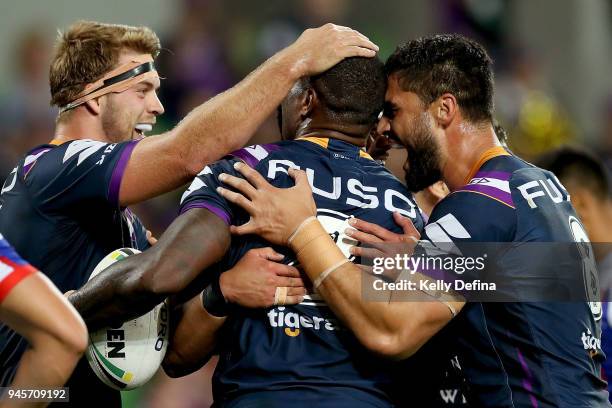 Suliasi Vunivalu of the Storm celebrates his try with Camerson Munster and Jesse Bromwich during the round six NRL match between the Melbourne Storm...