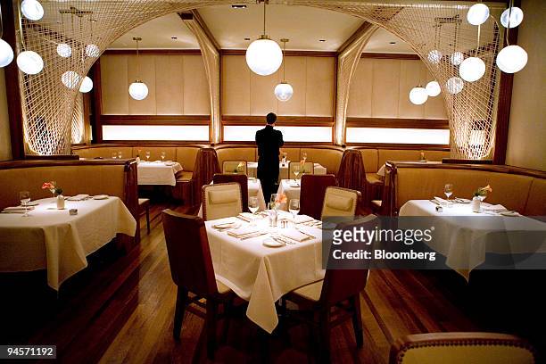Waiter sets tables before dinner service at Brasserie 44 at the Royalton Hotel in New York, U.S., on Friday, Nov. 2, 2007. Boring restaurants happen...