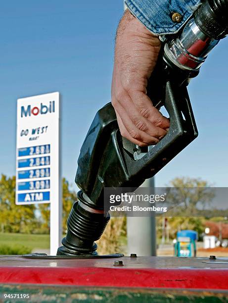 Man pumps gasoline into the tank of a welding machine at a Mobil gas station in St. Louis, Missouri, Thursday, Nov. 1, 2007. Exxon Mobil Corp. And...