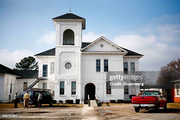 Local residents talk in front of a classroom building at the J.V. Martin Junior High School in Dillon, South Carolina, U.S., on Wednesday, Jan. 23,...