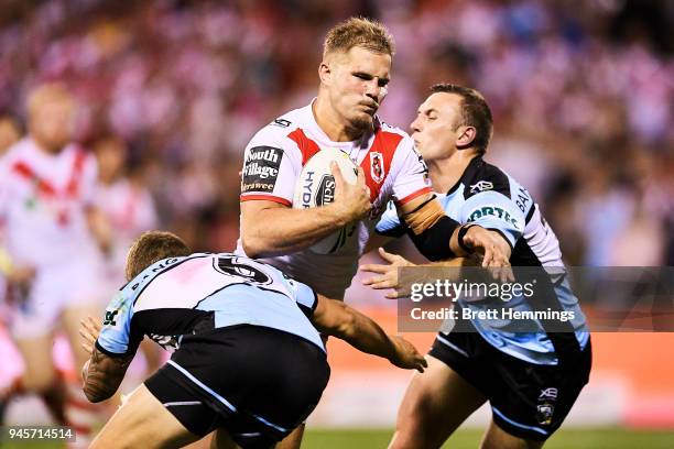 Jack De Belin of the Dragons is tackled during the round six NRL match between the St George Illawarra Dragons and the Cronulla Sharks at WIN Stadium...