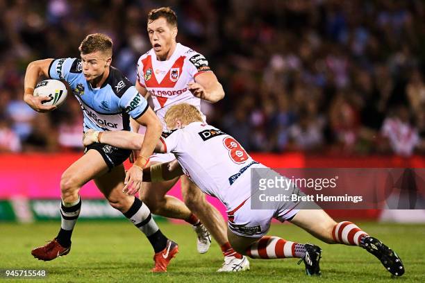 Jayden Brailey of the Sharks is tackled during the round six NRL match between the St George Illawarra Dragons and the Cronulla Sharks at WIN Stadium...