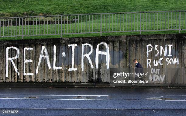 Young boy walks past political graffiti on a wall in the Bogside area of Londonderry, Northern Ireland, on Thursday, Nov. 8, 2007. A 43-year-old...