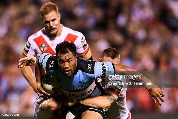 Joseph Paulo of the Sharks is tackled during the round six NRL match between the St George Illawarra Dragons and the Cronulla Sharks at WIN Stadium...