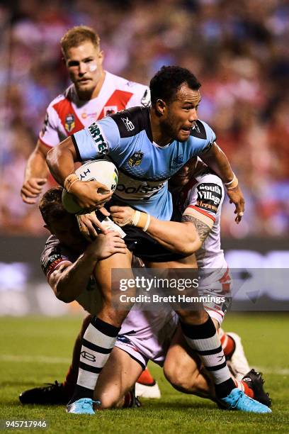 Joseph Paulo of the Sharks is tackled during the round six NRL match between the St George Illawarra Dragons and the Cronulla Sharks at WIN Stadium...