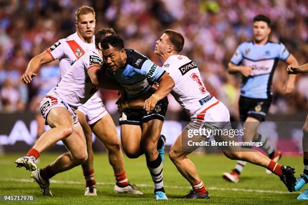 Joseph Paulo of the Sharks is tackled during the round six NRL match between the St George Illawarra Dragons and the Cronulla Sharks at WIN Stadium...