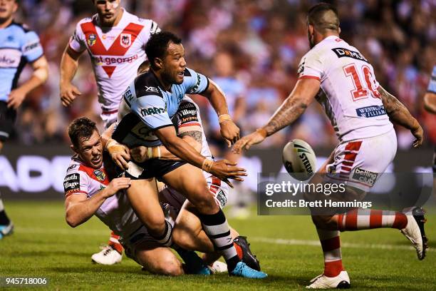 Joseph Paulo of the Sharks is tackled during the round six NRL match between the St George Illawarra Dragons and the Cronulla Sharks at WIN Stadium...