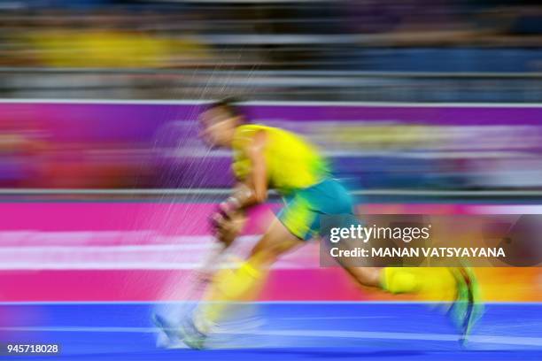 Australia's Tom Craig makes a run with the ball against England during their men's field hockey semi-final match at the 2018 Gold Coast Commonwealth...