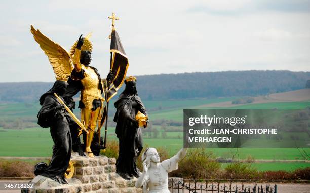 The sculpture "Jeanne d'Arc and his voices" is pictured in front of Bois-Chenu's basilica, dedicated to Jeanne d'Arc , on April 12, 2018 in...