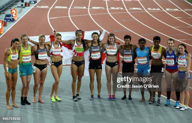 Silver medalist Nina Schultz of Canada, gold medalist Katarina Johnson-Thompson of England and bronze medalist Niamh Emerson of England celebrate...