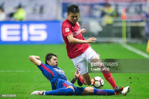 Oscar Romero of Shanghai Shenhua and Zou Zheng of Guangzhou Evergrande compete for the ball during the 2018 Chinese Super League 6th round match...