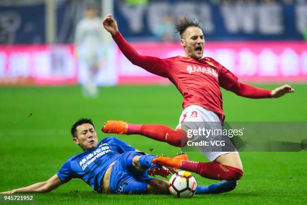 Qin Sheng of Shanghai Shenhua and Nemanja Gudelj of Guangzhou Evergrande compete for the ball during the 2018 Chinese Super League 6th round match...