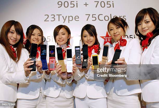 Models display NTT DoCoMo Inc.'s new range of mobile phones during a product launch event in Tokyo, Japan, on Thursday, Nov. 1, 2007. NTT DoCoMo...