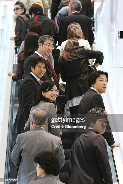 Shoppers ride an escalator at J. Front Retailing Co. 's Daimaru department store in the GranTokyo towers in Tokyo, Japan, on Tuesday, Nov. 6, 2007....