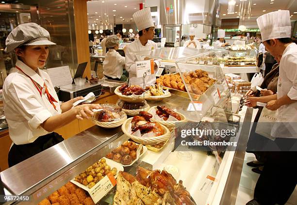 Sales clerks prepare to open a delicatessen booth at J. Front Retailing Co. 's Daimaru department store in the GranTokyo towers in Tokyo, Japan, on...