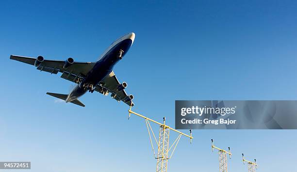 commercial plane landing - greg bajor stock-fotos und bilder