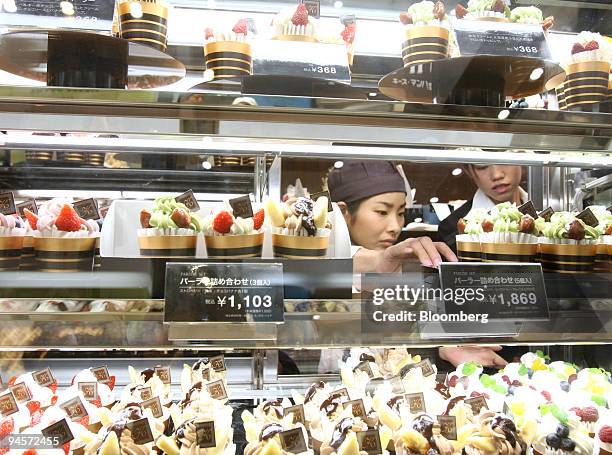 Sales clerks prepare to open a cake shop at J. Front Retailing Co. 's Daimaru department store in the GranTokyo towers in Tokyo, Japan, on Tuesday,...