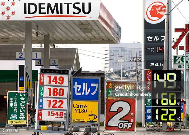 Signs including those showing gasoline prices fill the forecourt of an Idemitsu Kosan Co. Gas station in Tokyo, Japan, on Monday, Nov. 5, 2007....