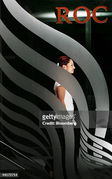 An employee walks past the logo for Roc Oil Co. In the foyer of their offices in Sydney, Australia, on Wednesday, Oct. 31, 2007. Roc Oil Co., the oil...