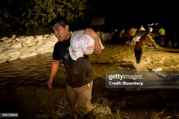 Residents of Villahermosa, Tabasco State, Mexico, carry sand bags to guard against flooding on Friday, Nov. 2, 2007. Mexico's Red Cross is preparing...