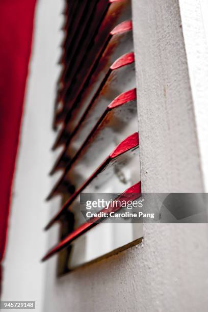 wooden white window pane with red flips. - caroline pang stockfoto's en -beelden