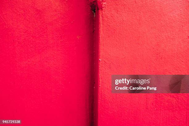 red wall. - caroline pang stock pictures, royalty-free photos & images