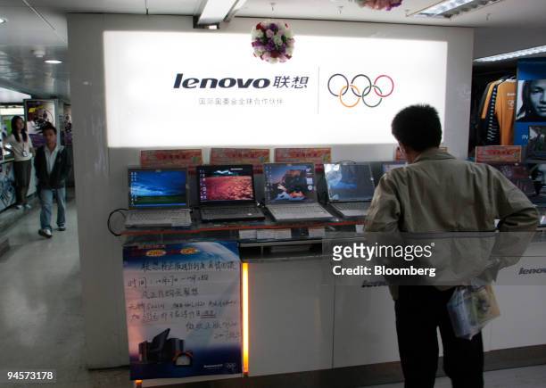 Customer looks at Lenovo Group Ltd. Computers at a market in Shanghai, China, on Wednesday, Oct. 31, 2007. Lenovo Group Ltd., the world's...