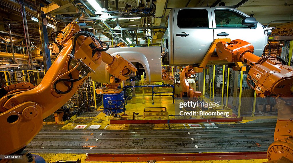 Robotic arms "marry up" the cab, box and chassis of a pick-u