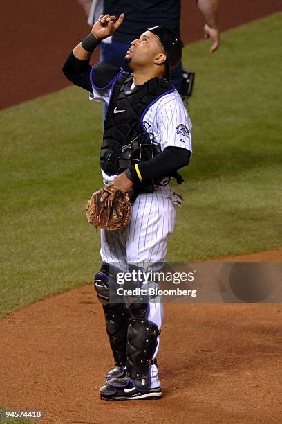 Colorado Rockies catcher Yorvit Torrealba points skyward before catching for Aaron Cook against the Boston Red Sox during Game 4 of the Major League...