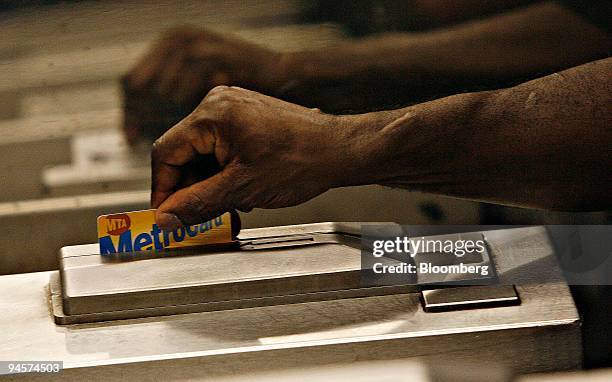 Subway rider swipes his Metro Card, Wednesday, July 25 in the Herald Square subway station in New York. New York's Metropolitan Transportation...