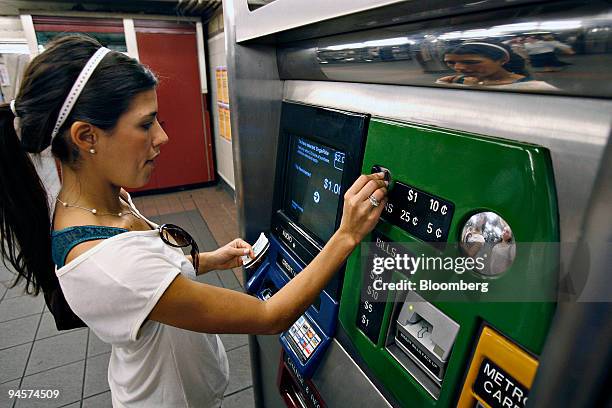 Celita Whitaker purchases a single ride subway ticket from a vending machine, Wednesday, July 25 in the Herald Square subway station in New York. New...