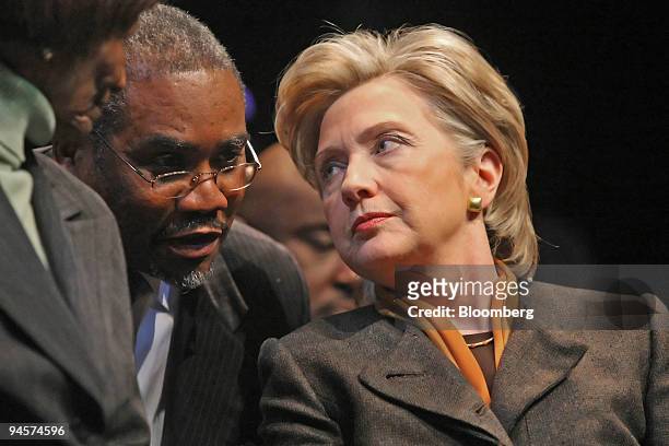 Hillary Clinton, U.S. Senator from New York and 2008 Democratic presidential candidate, leans back to listen to an unidentified man during a Service...