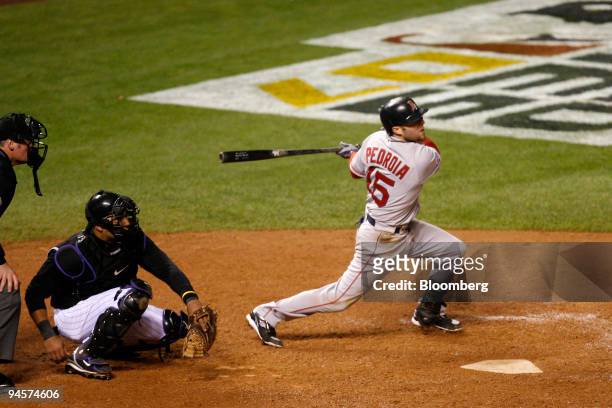Dustin Pedroia of the Boston Red Sox hits a two RBI double against the Colorado Rockies during Game 3 of the Major League Baseball World Series at...