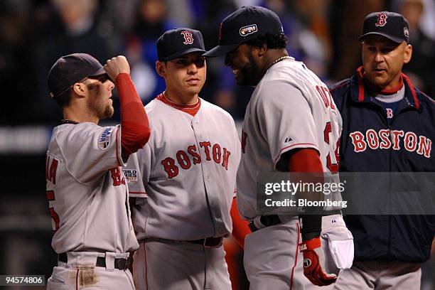 David Ortiz of the Boston Red Sox, right, greets teammate Dustin Pedroia, left, before playing against the Colorado Rockies in Game 3 of the Major...