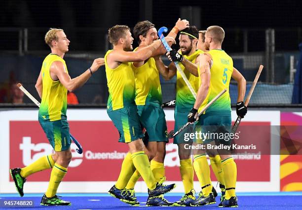 Trent Mitton of Australia is congratulated by team mates after scoring a goal in the semi final match between Australia and England during Hockey on...