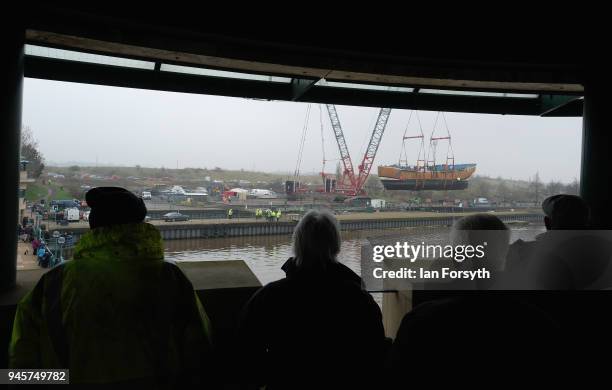 Replica of Captain Cook's famous ship, HM Bark Endeavour, is hoisted by crane over the lock gates on the River Tees barrage as it undergoes...