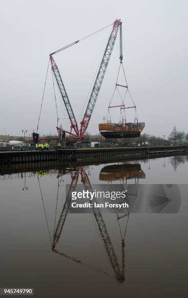 Replica of Captain Cook's famous ship, HM Bark Endeavour, is hoisted by crane over the lock gates on the River Tees barrage as it undergoes...