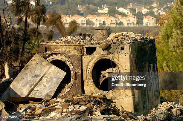 Washer and dryer stand in the wreckage of a home in Rancho Bernardo, California, U.S., following the Witch fire on Friday, Oct. 26, 2007....