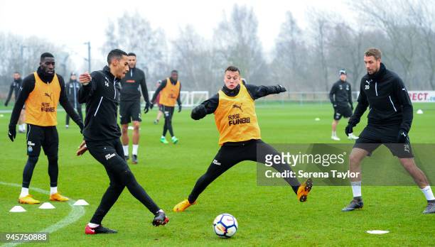 Isaac Hayden passes the ball in a game of possession whilst Javier Manquillo lunges to intercept the pass during the Newcastle United Training...