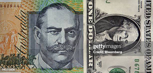 An Australian one-hundred-dollar note is displayed against an American one-dollar bill, in Sydney, Australia, on Tuesday, July 24, 2007. Anyone who...